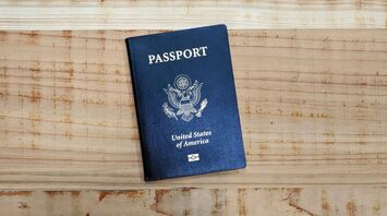 U.S. passport lying on a wooden surface