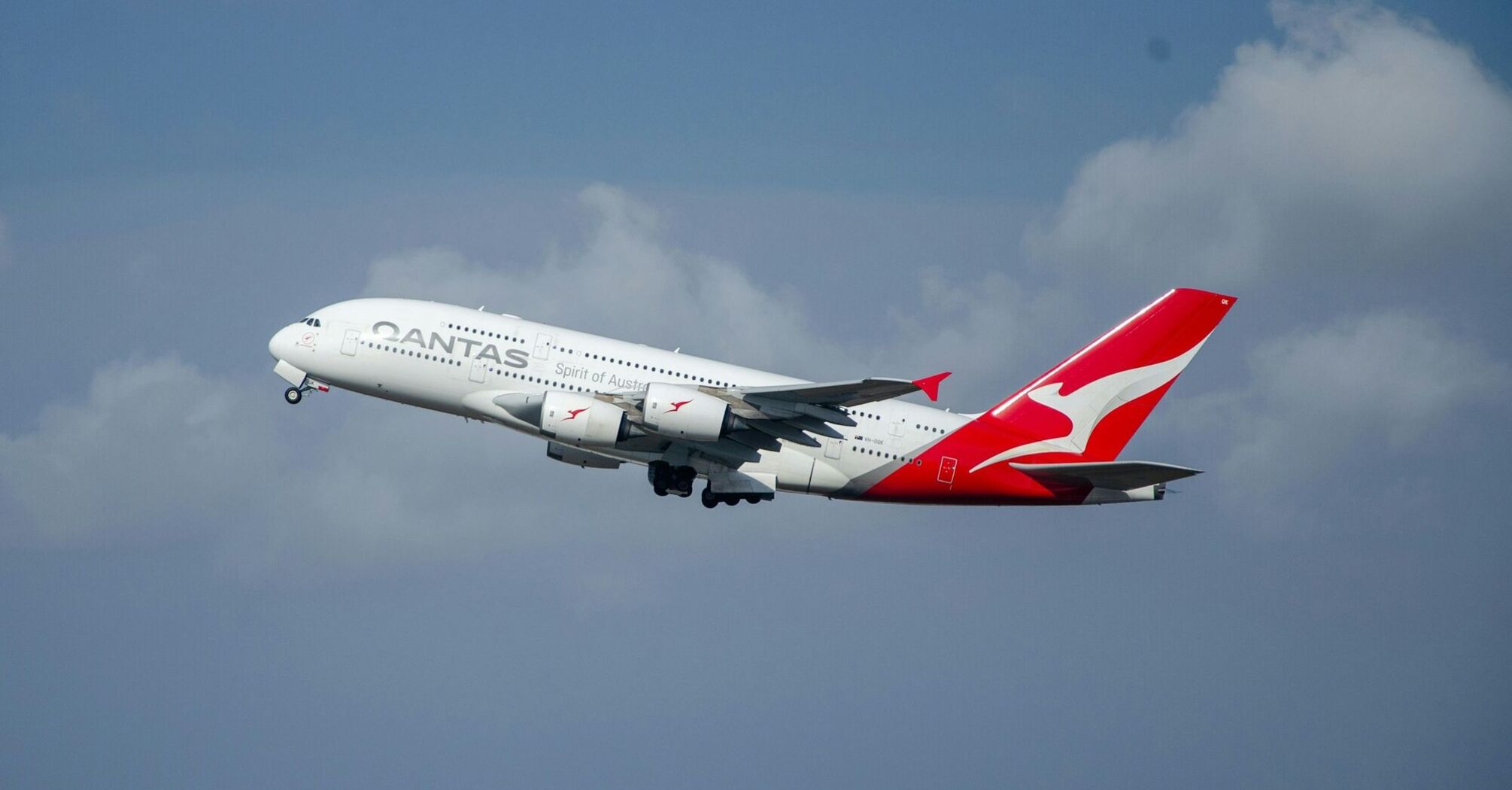 Qantas airplane taking off under a cloudy sky