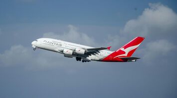 Qantas airplane taking off under a cloudy sky