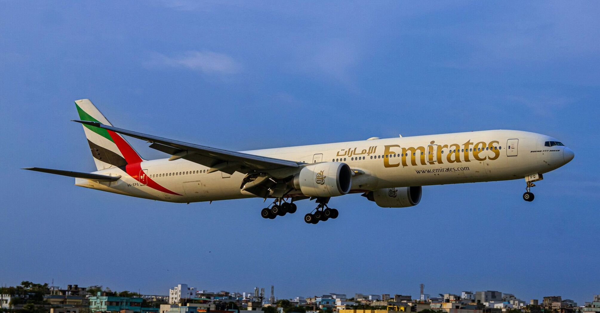 a large jetliner flying through a blue sky