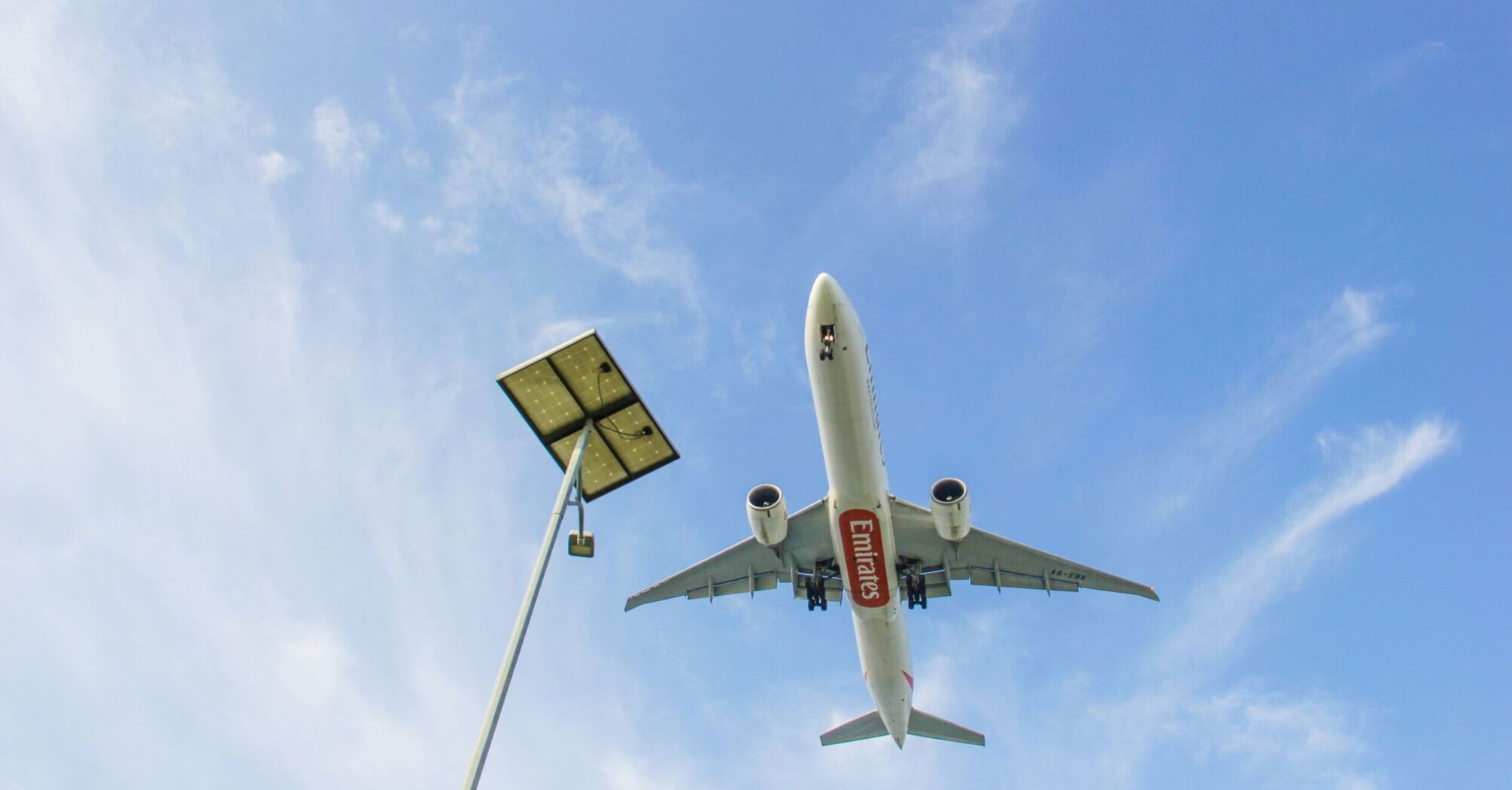 a large jetliner flying through a blue sky