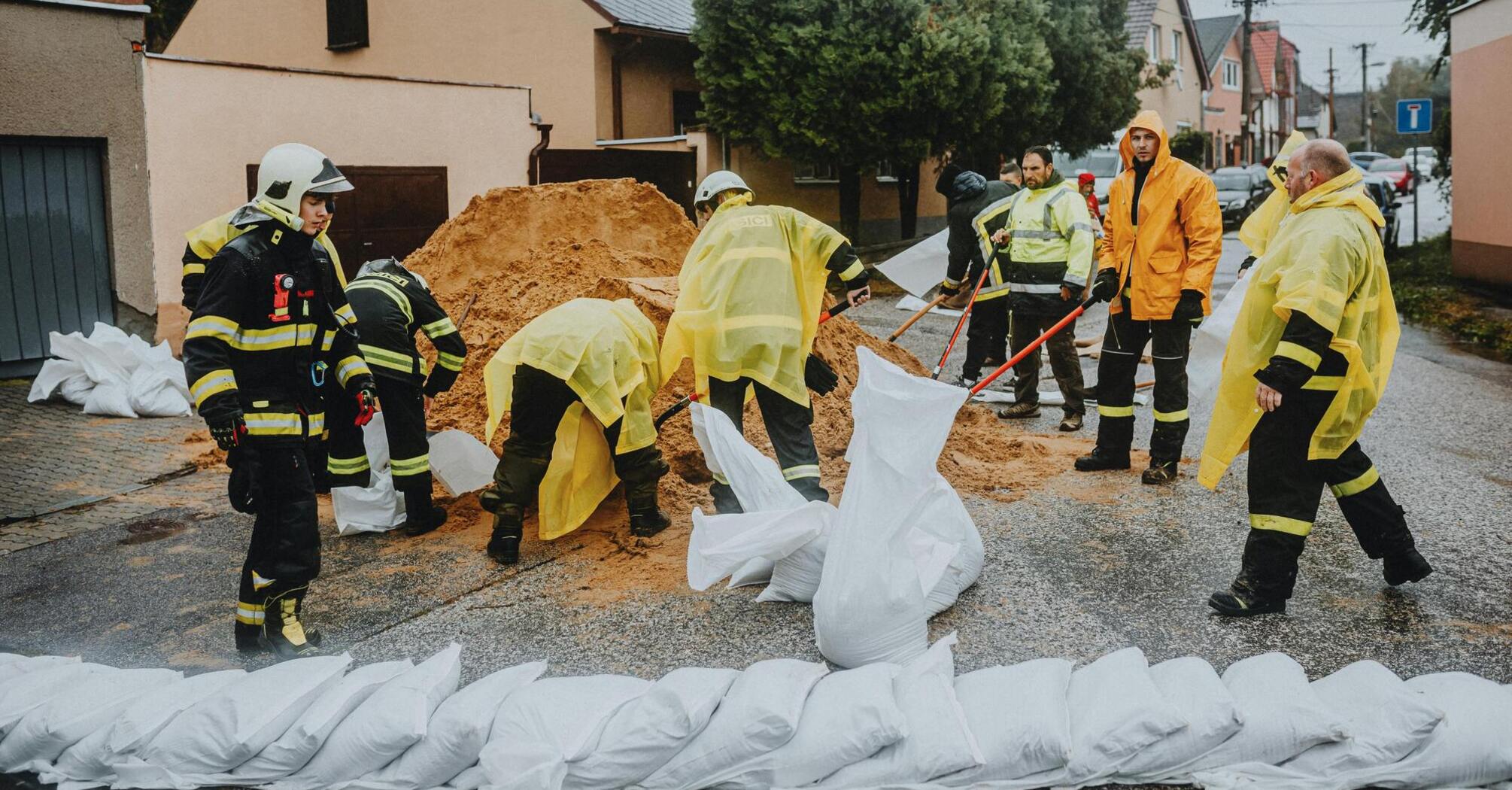 Emergency workers prepare sandbags to prevent flood damage