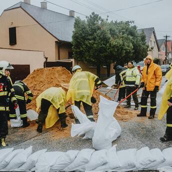Emergency workers prepare sandbags to prevent flood damage