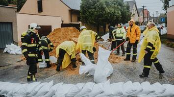 Emergency workers prepare sandbags to prevent flood damage