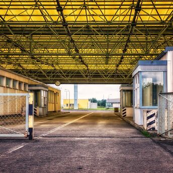 Empty border checkpoint with yellow roof structure