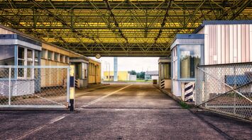 Empty border checkpoint with yellow roof structure