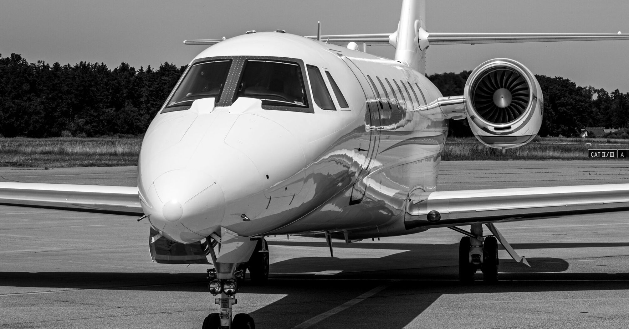 Private jet parked on an airport runway