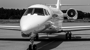 Private jet parked on an airport runway