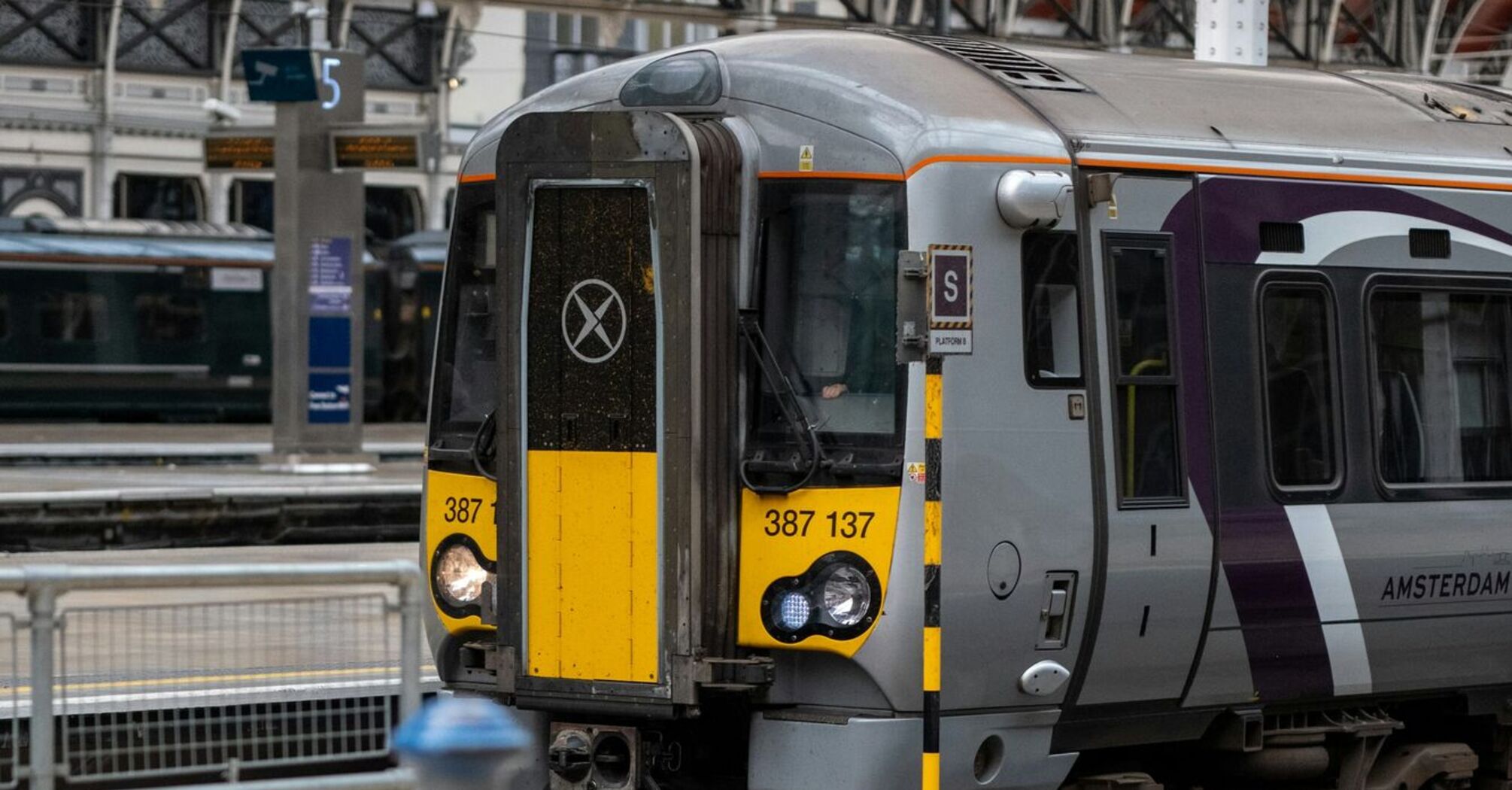 A Heathrow Express train standing at a platform inside a railway station