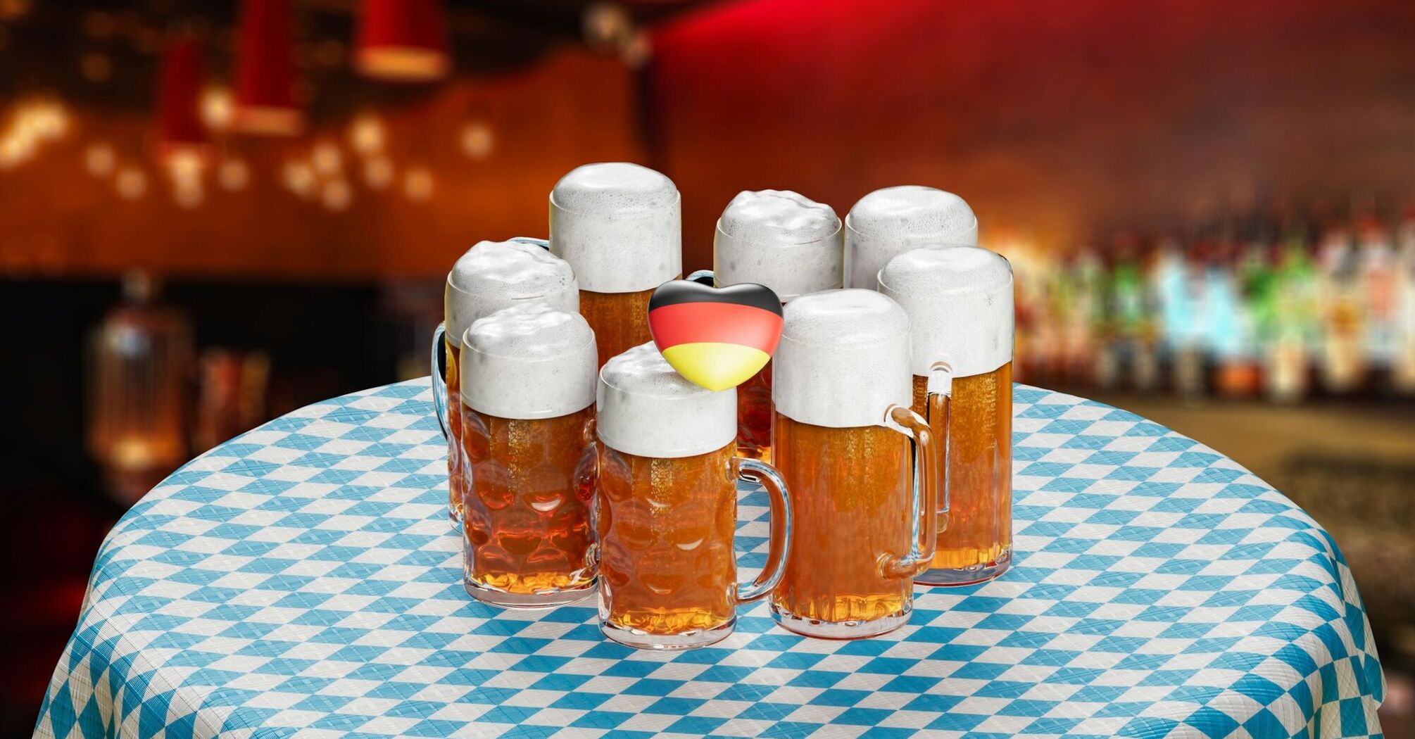 Beers served in traditional frothy mugs on a checkered Oktoberfest table