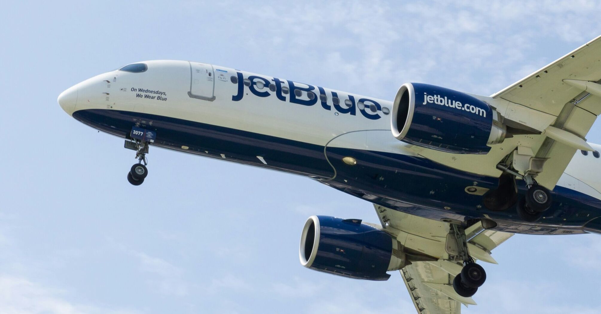 a jetblue airplane is flying in the sky