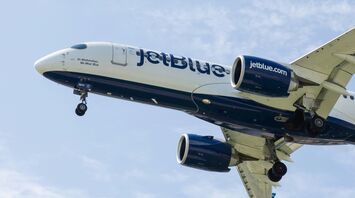 a jetblue airplane is flying in the sky