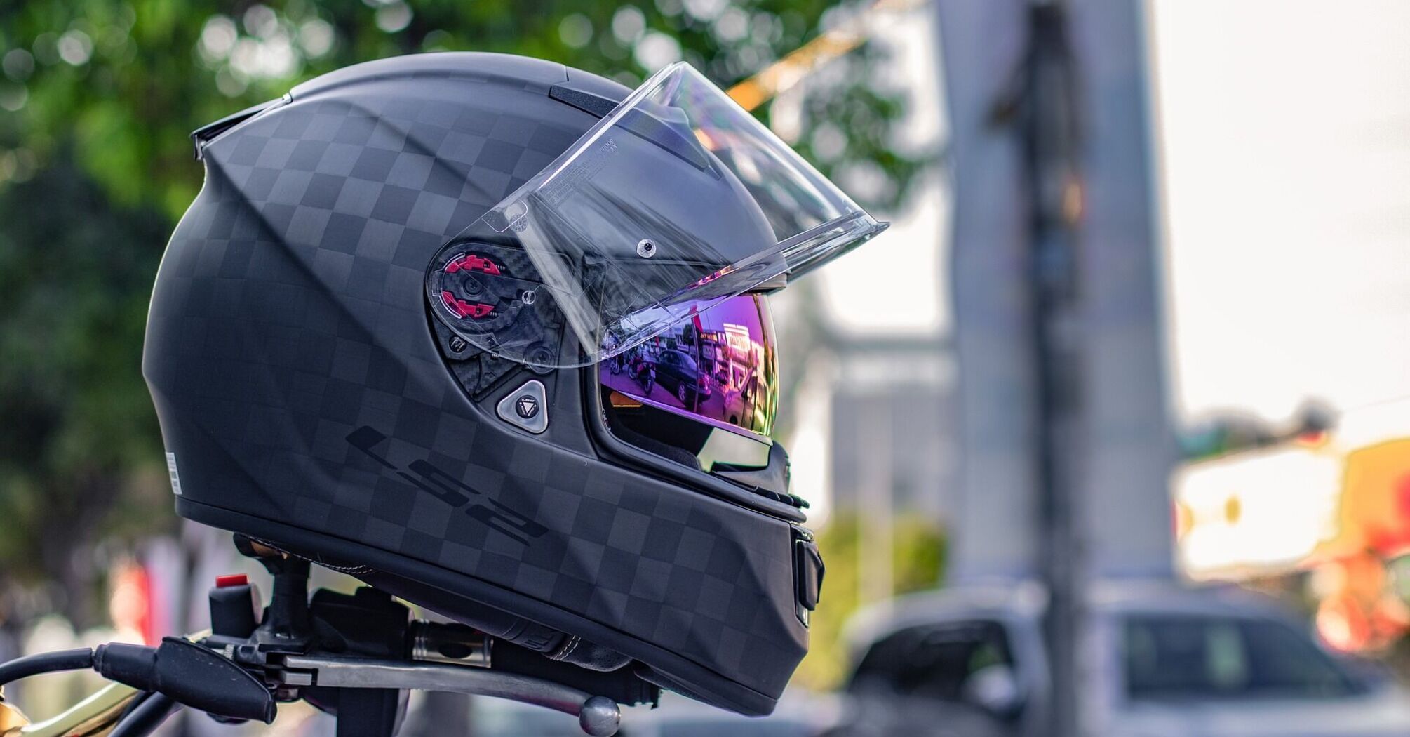 Black motorcycle helmet with reflective visor