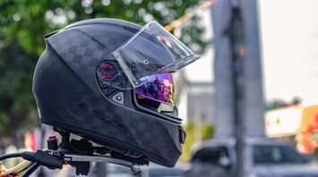 Black motorcycle helmet with reflective visor