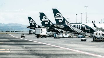 Air New Zealand planes lined up on an airport runway, preparing for international flights