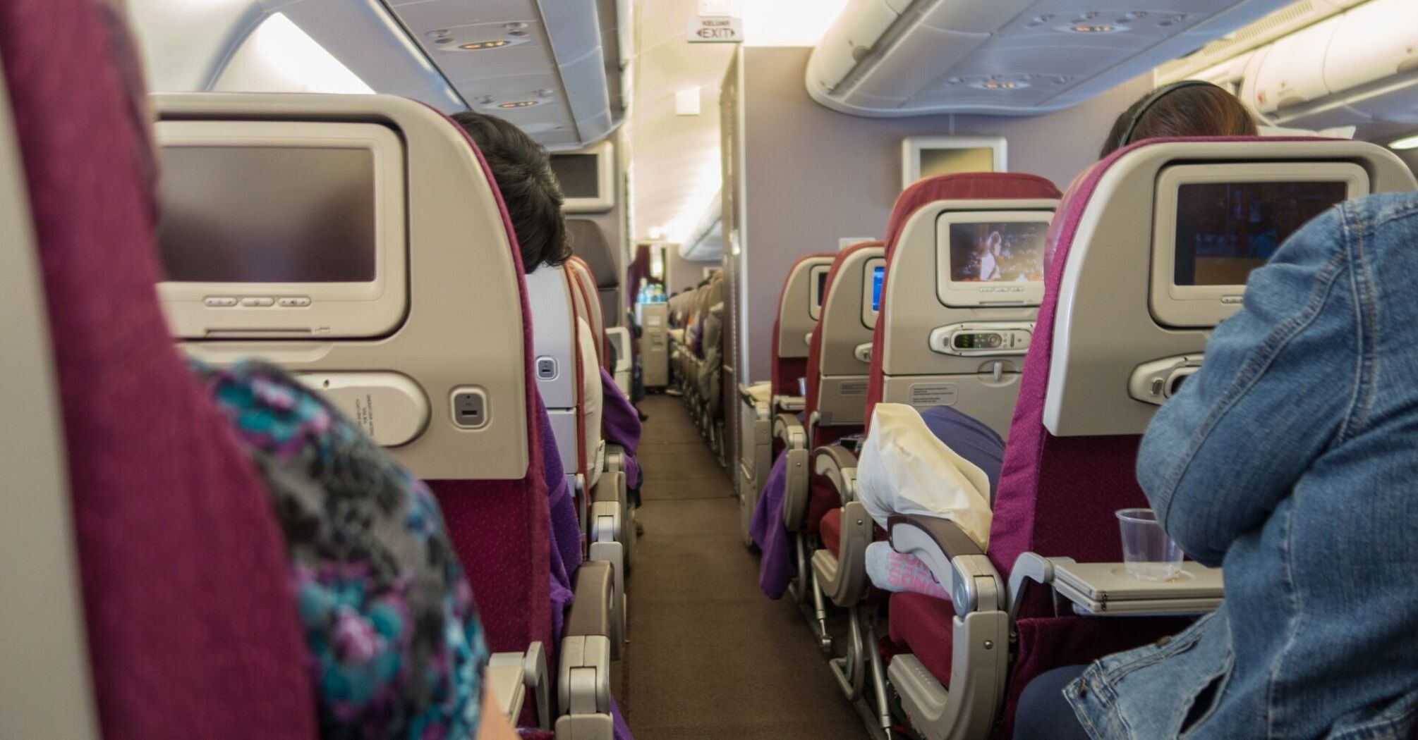 Interior view of an airplane with passengers seated