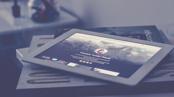 iPad lying on a table displaying a Tumblr theme