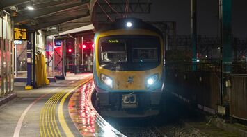 A TransPennine Express train bound for York, waiting at a station platform during the night