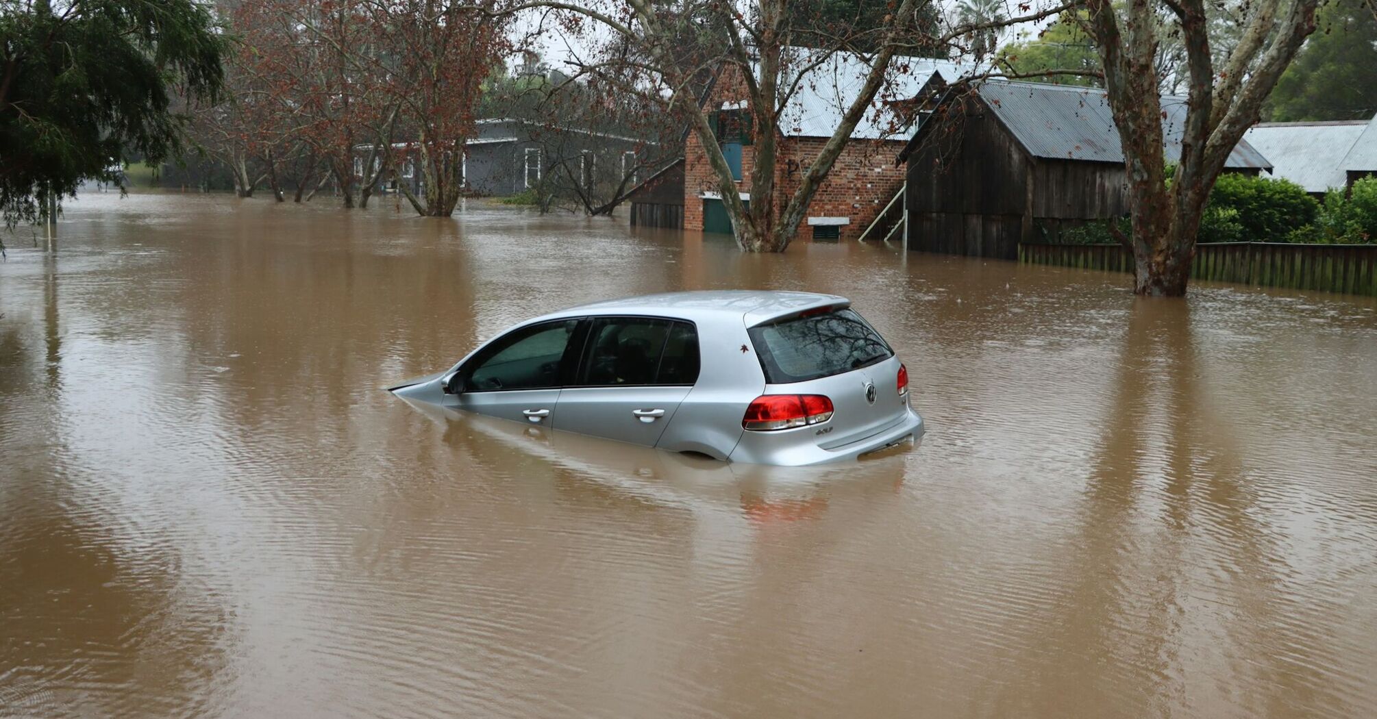 Submerged car in a flooded residential area