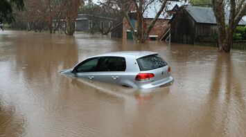 Submerged car in a flooded residential area