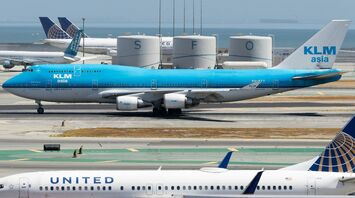 KLM plane taxiing at an airport alongside United Airlines planes