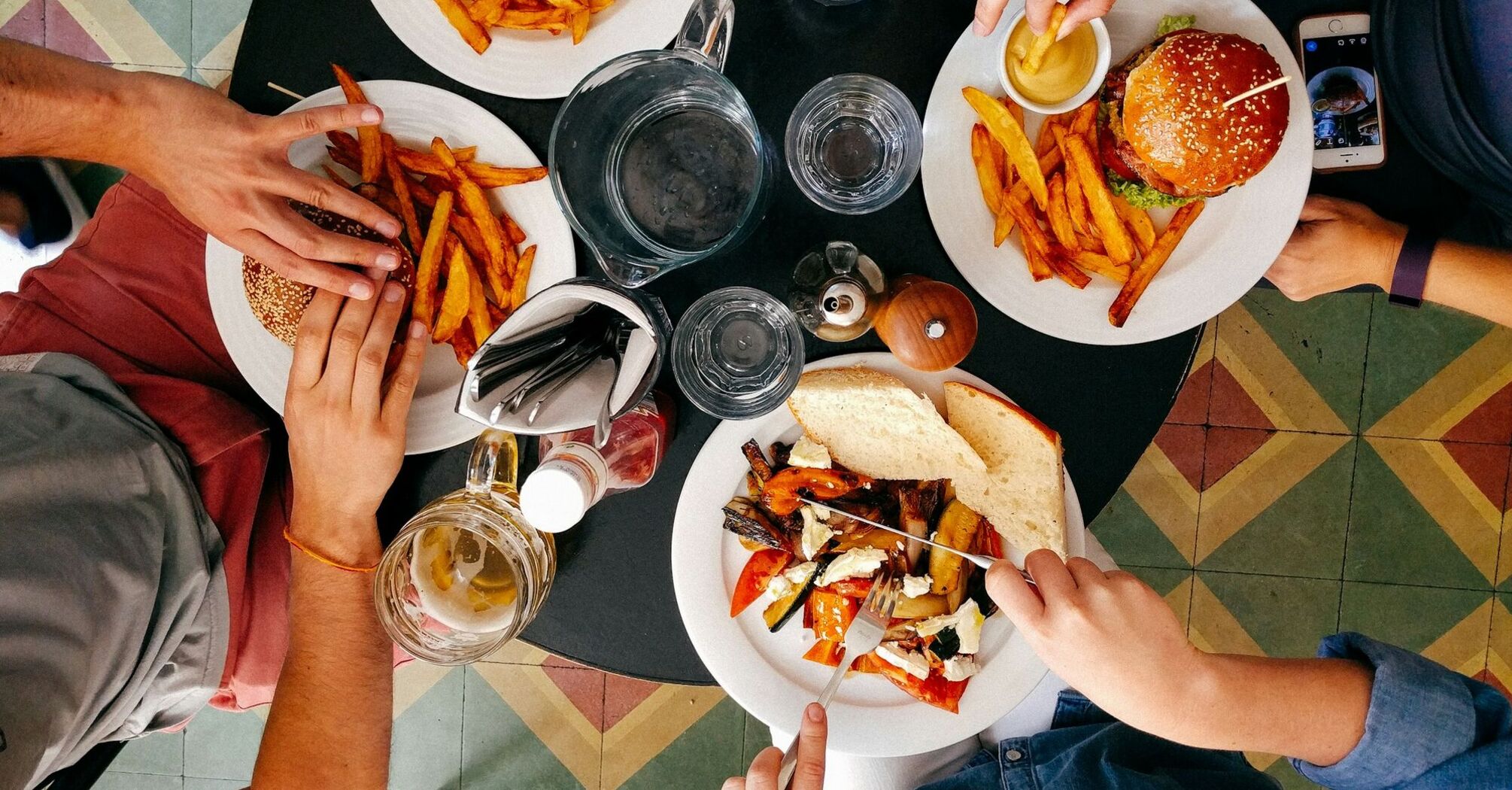 People enjoying burgers and fries at a restaurant