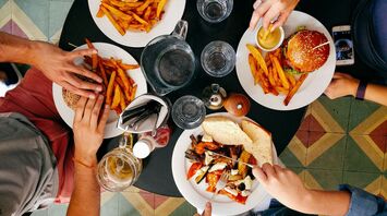 People enjoying burgers and fries at a restaurant