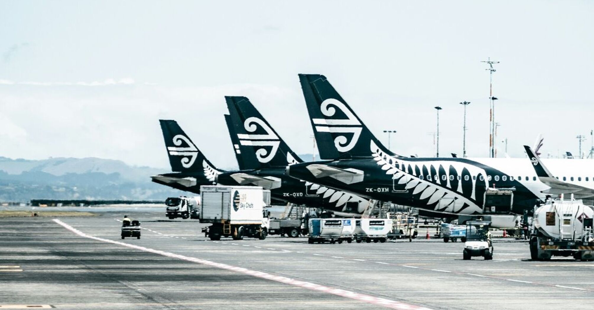 Air New Zealand planes parked at the airport terminal, preparing for flights