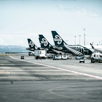 Air New Zealand planes parked at the airport terminal, preparing for flights