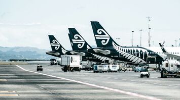 Air New Zealand planes parked at the airport terminal, preparing for flights