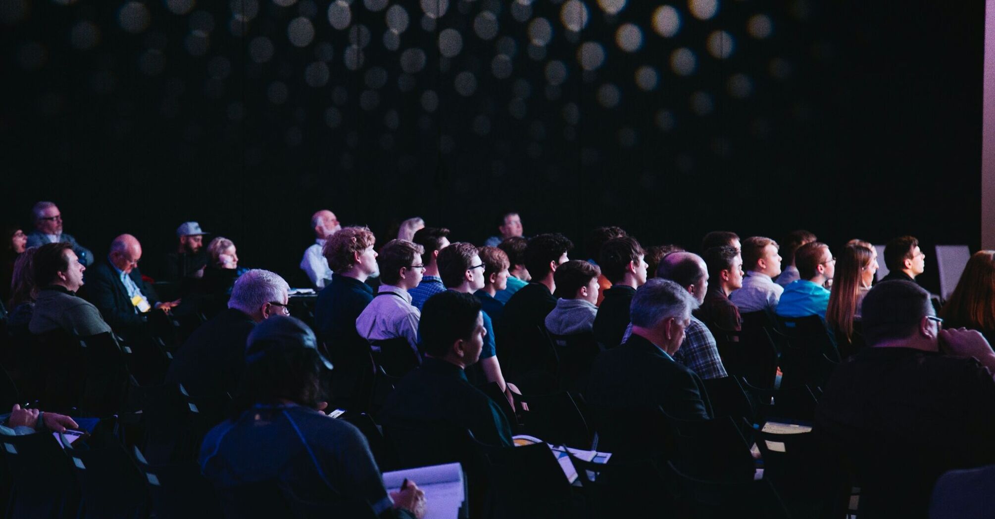 Audience attentively listening during a formal presentation or conference event