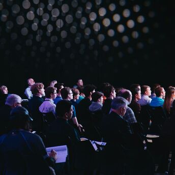 Audience attentively listening during a formal presentation or conference event