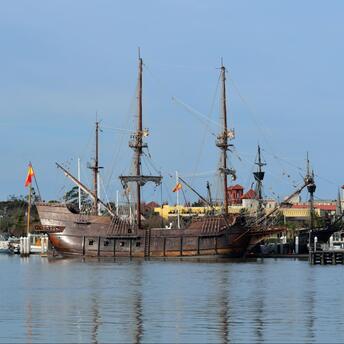17th-century Spanish galleon replica docked in a sunny harbor