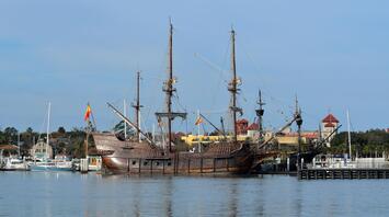 17th-century Spanish galleon replica docked in a sunny harbor