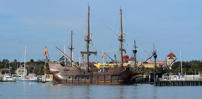 17th-century Spanish galleon replica docked in a sunny harbor