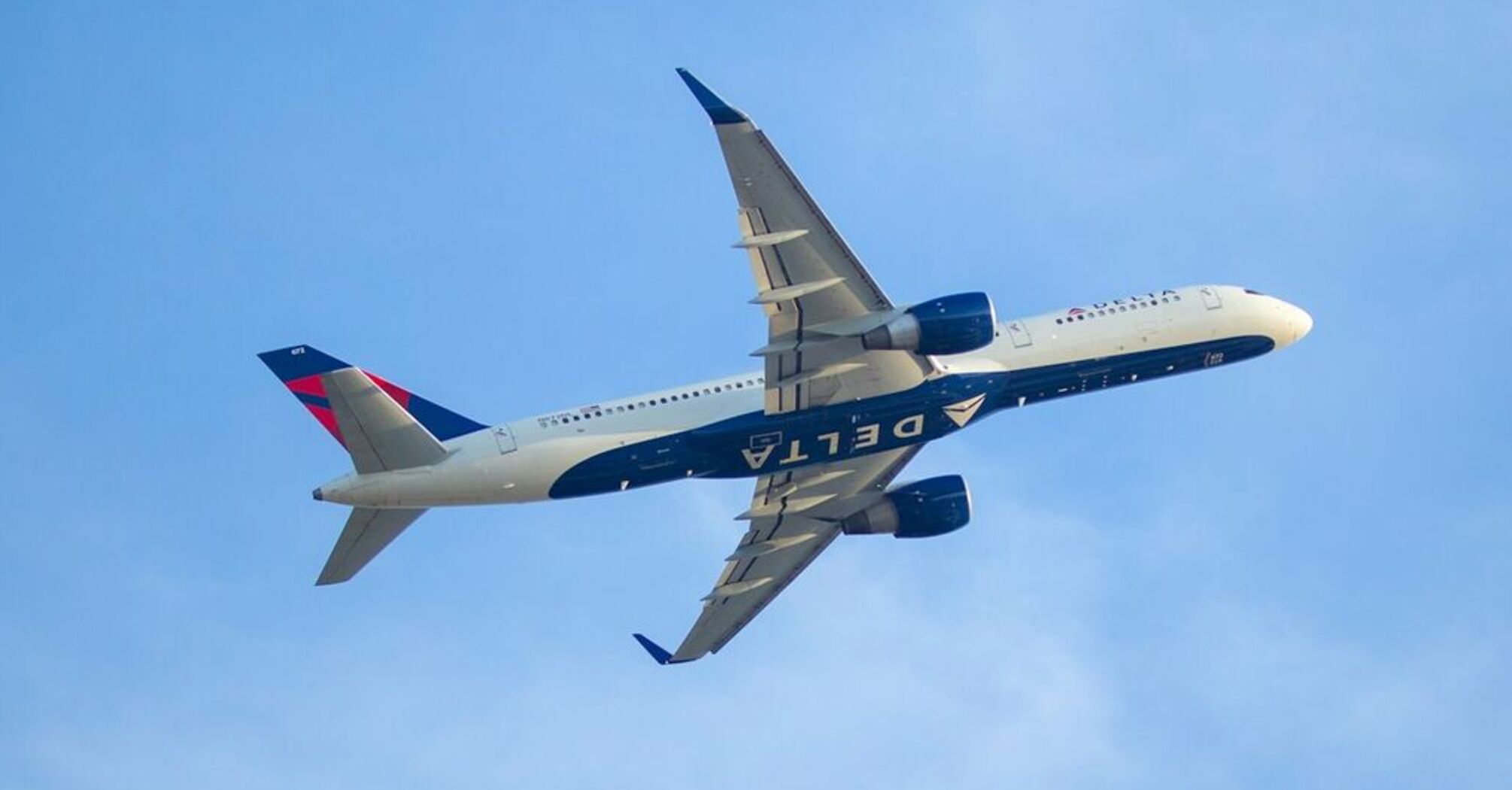 A Delta Airlines Airbus A350 aircraft flying through a clear blue sky