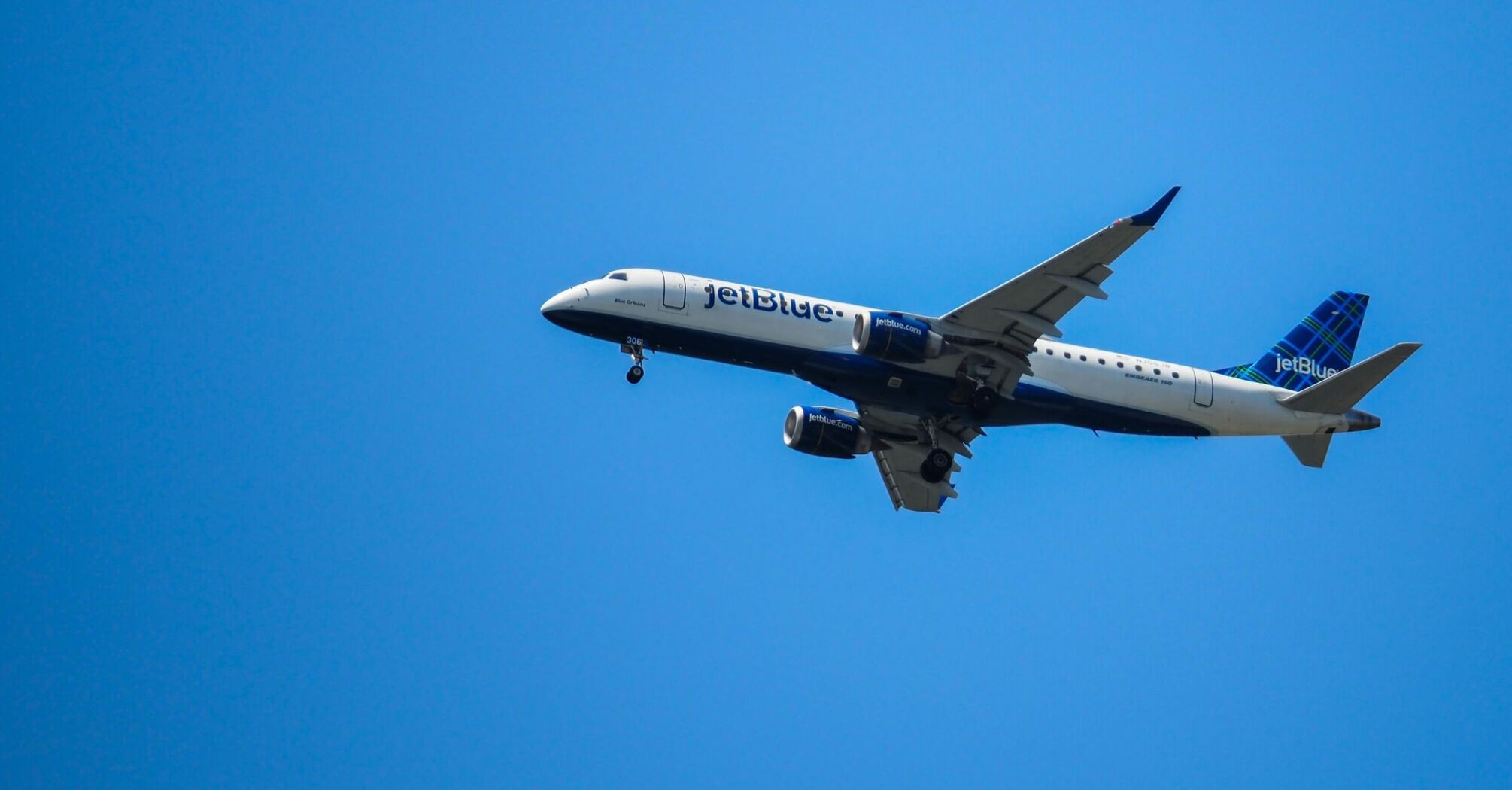 a large jetliner flying through a blue sky