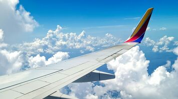 Wing of a Southwest Airlines plane in flight, above the clouds