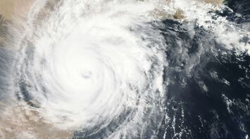 Satellite image of a hurricane forming over the ocean and approaching land