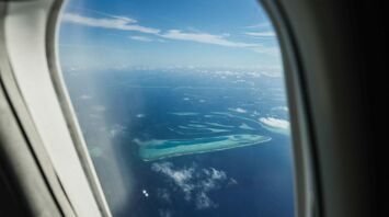 Aerial view of the Maldives' atolls seen through an airplane window