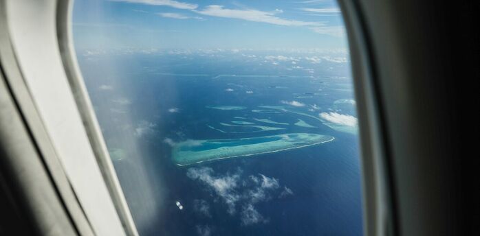 Aerial view of the Maldives' atolls seen through an airplane window