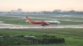 VietJet airplane taxiing on a runway at an airport