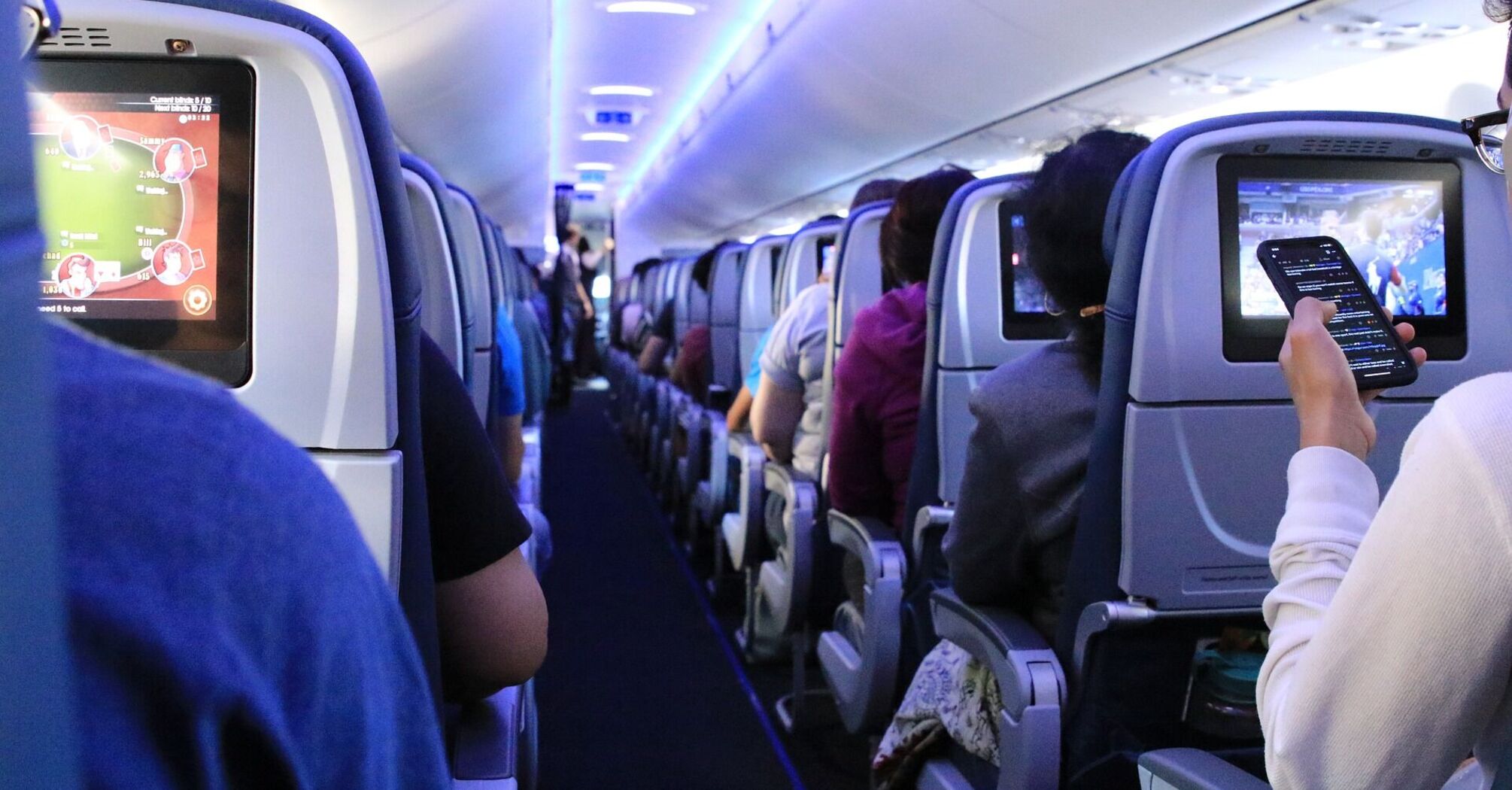 Passengers seated inside an airplane cabin during flight