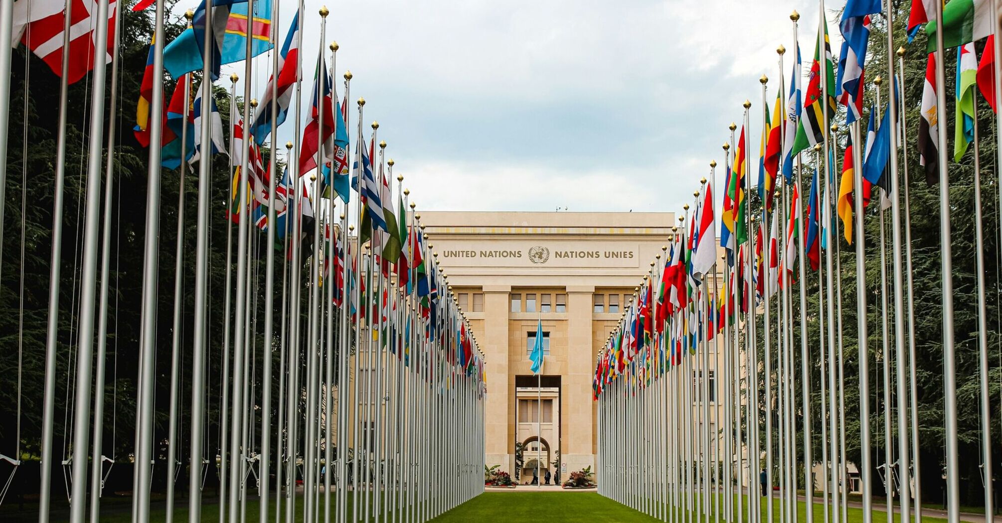 United Nations building with flags of various countries lining the entrance