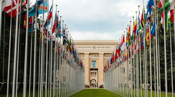 United Nations building with flags of various countries lining the entrance
