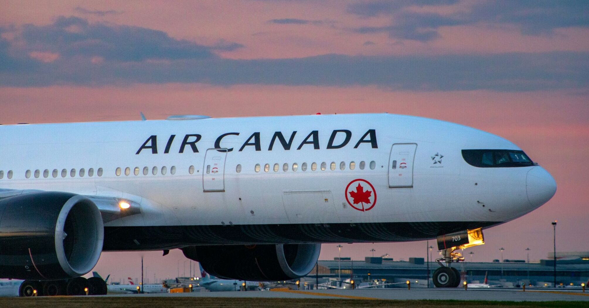 Air Canada airplane at an airport during sunset