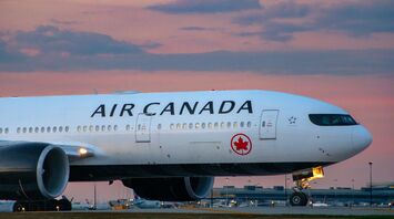 Air Canada airplane at an airport during sunset