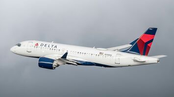 Delta Air Lines aircraft in mid-flight against a cloudy sky