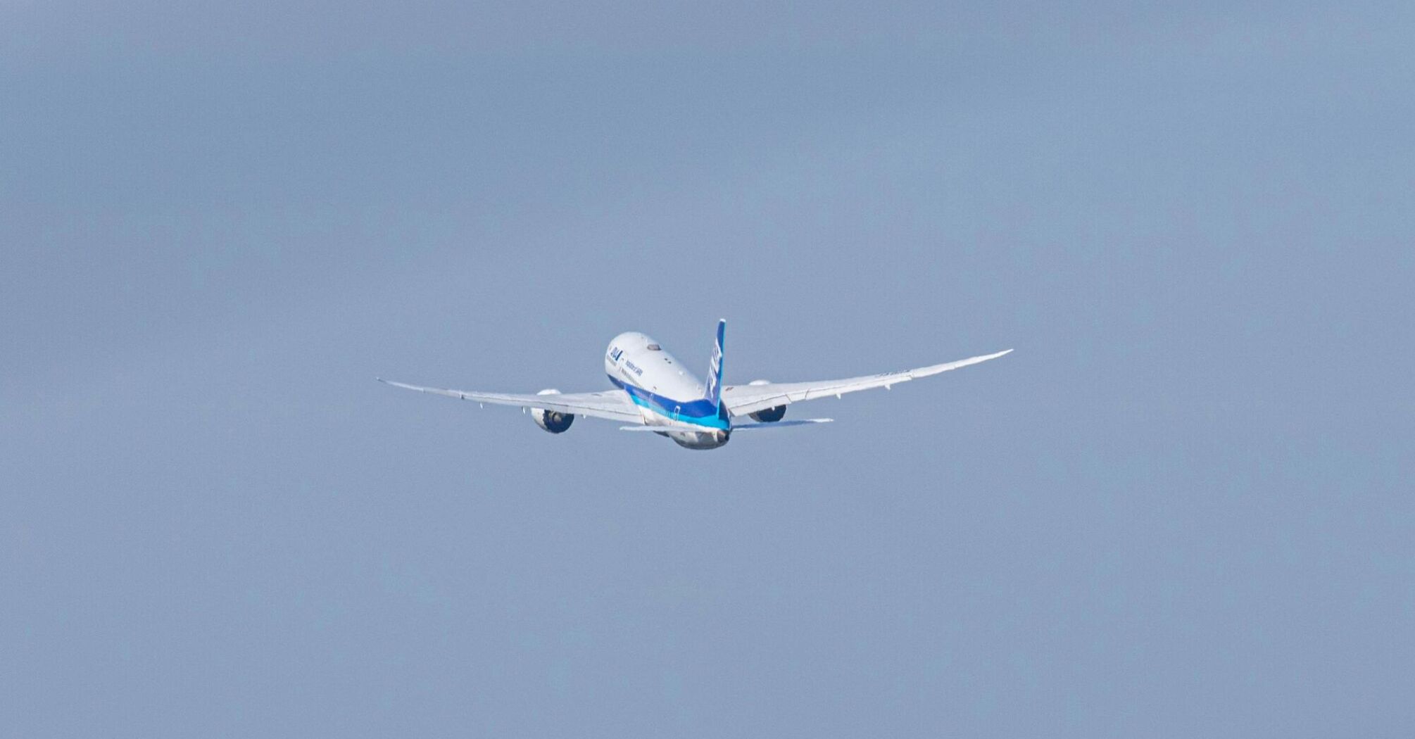 a large passenger jet flying through a blue sky