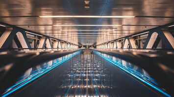 a very long and empty walkway with blue lights
